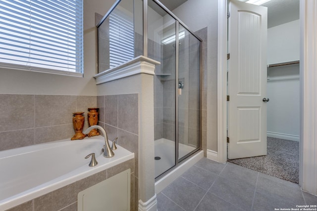 bathroom featuring separate shower and tub and tile patterned floors