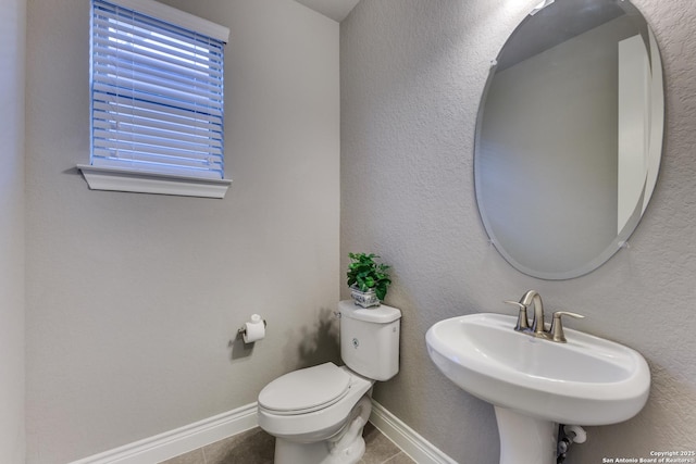 bathroom featuring sink, tile patterned floors, and toilet