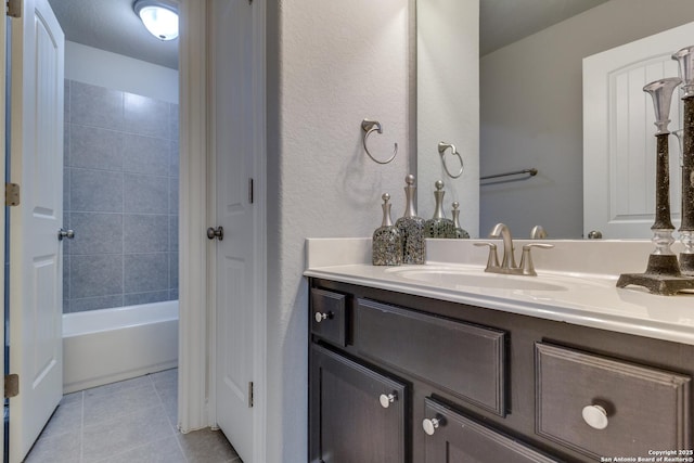 bathroom with tile patterned floors, bathing tub / shower combination, and vanity