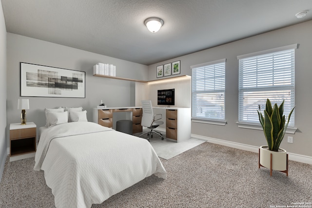 carpeted bedroom featuring a textured ceiling