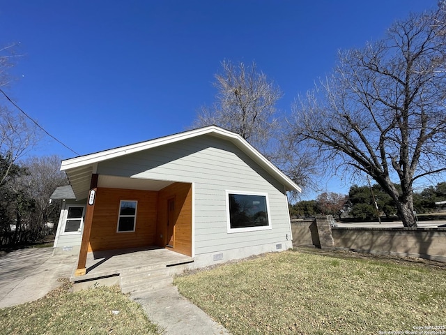 back of property with a lawn