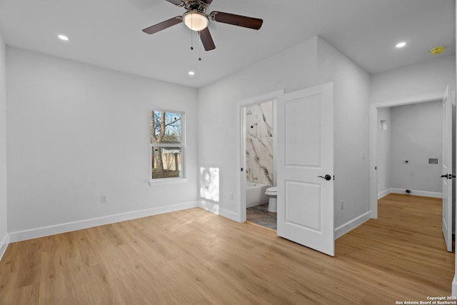 unfurnished bedroom with connected bathroom, ceiling fan, and light hardwood / wood-style flooring