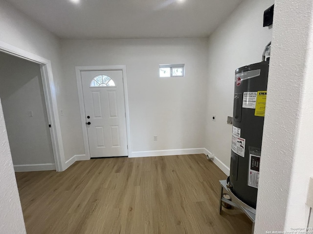 entrance foyer with water heater and light hardwood / wood-style flooring