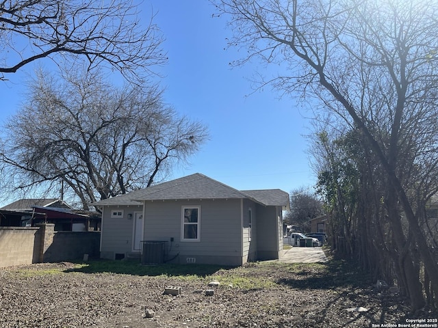 view of side of home with central AC unit