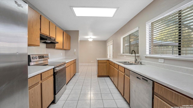 kitchen featuring sink, light tile patterned floors, and stainless steel appliances