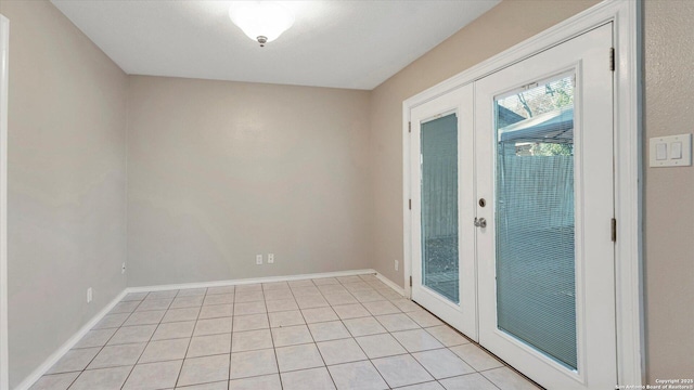 doorway to outside featuring light tile patterned floors and french doors