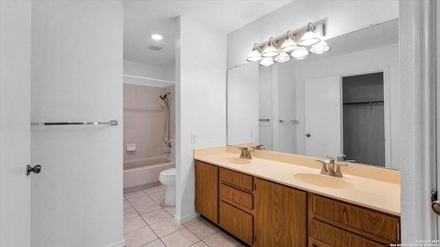 full bathroom with vanity, tiled shower / bath, tile patterned floors, and toilet