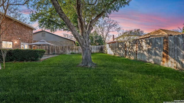 yard at dusk featuring a gazebo