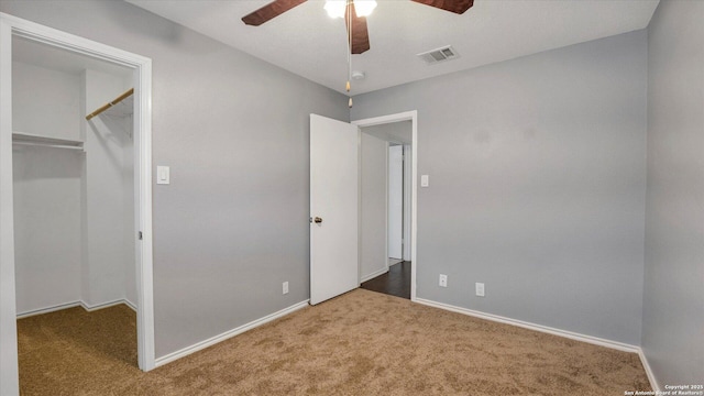 unfurnished bedroom with a closet, ceiling fan, and carpet flooring