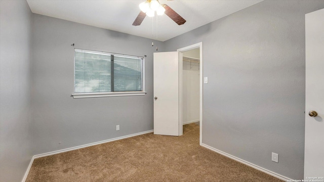 spare room featuring ceiling fan and light colored carpet