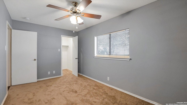 unfurnished bedroom featuring ceiling fan and light colored carpet