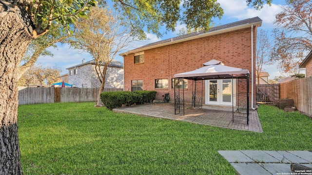 back of house featuring a gazebo, a yard, a patio area, and french doors