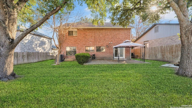 rear view of house with a gazebo, a yard, a patio, and cooling unit