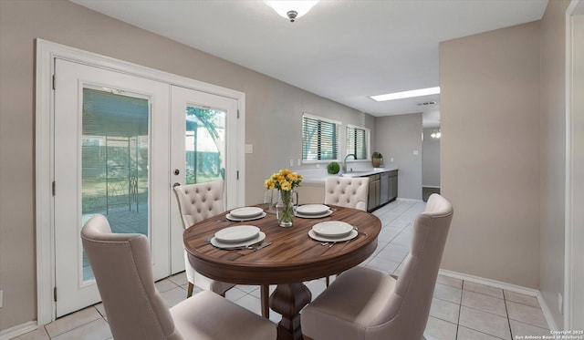 dining space with light tile patterned floors, sink, and a healthy amount of sunlight