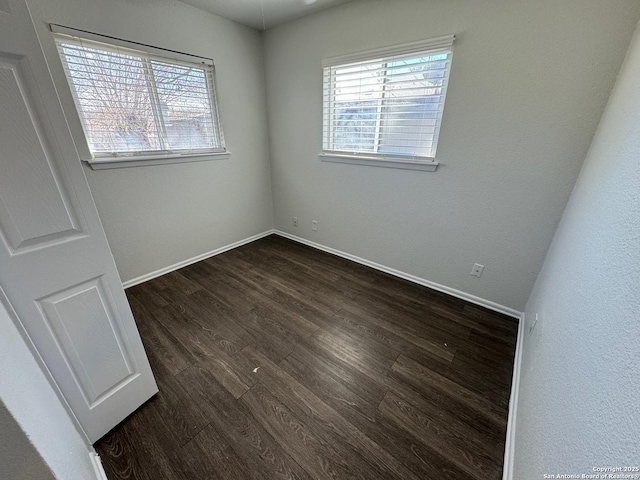 spare room featuring dark hardwood / wood-style flooring