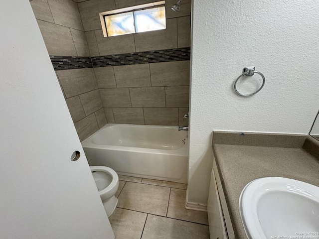 full bathroom featuring tile patterned flooring, tiled shower / bath combo, sink, and toilet