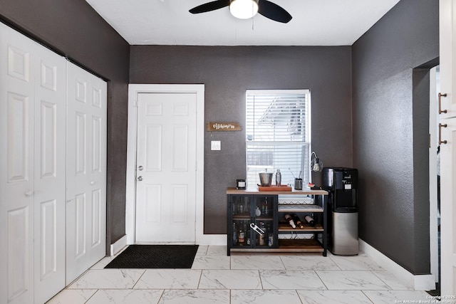 foyer entrance featuring ceiling fan