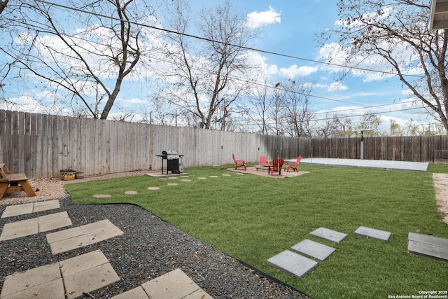 view of yard with a patio area and a fire pit