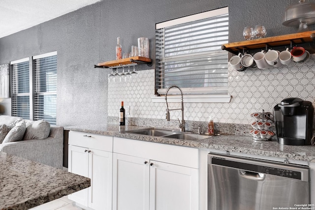 kitchen featuring white cabinetry, dishwasher, plenty of natural light, and sink