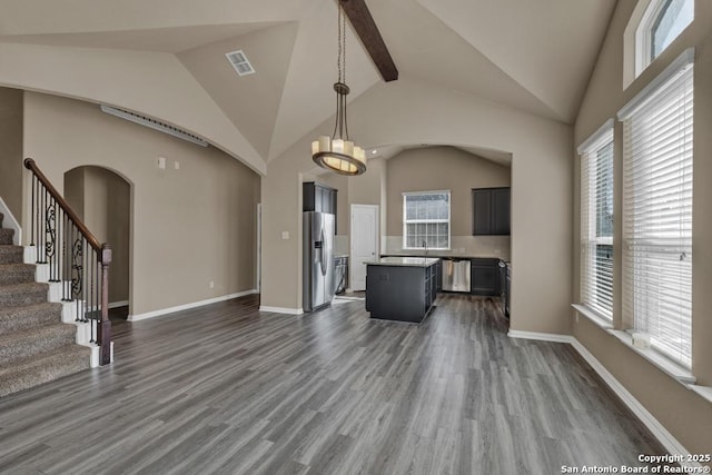 unfurnished living room featuring beamed ceiling, dark wood-type flooring, and high vaulted ceiling