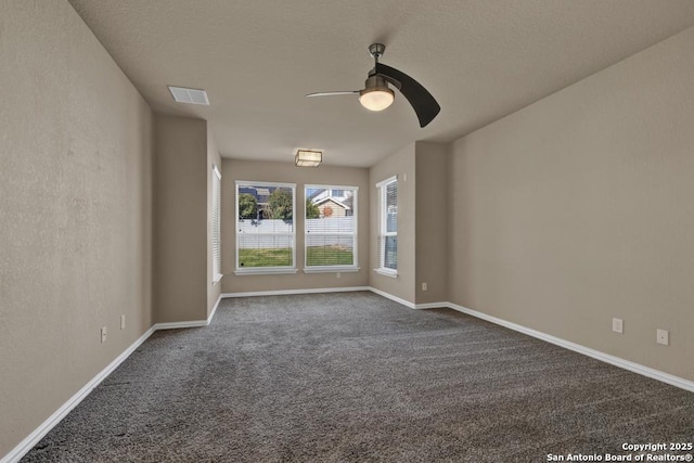 carpeted spare room featuring ceiling fan