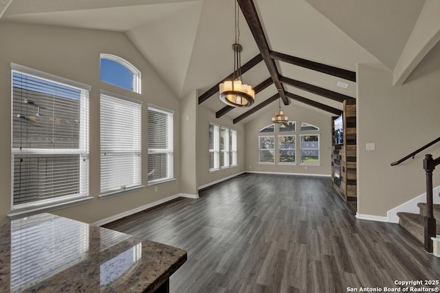 unfurnished living room with an inviting chandelier, dark wood-type flooring, and vaulted ceiling