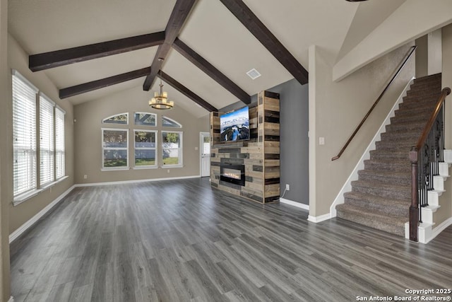 unfurnished living room with high vaulted ceiling, dark hardwood / wood-style floors, a notable chandelier, a fireplace, and beamed ceiling