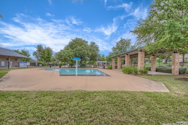 view of swimming pool featuring a patio area and a lawn