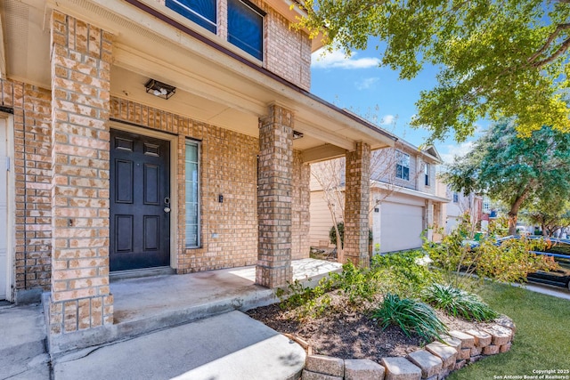 doorway to property featuring a porch and a garage