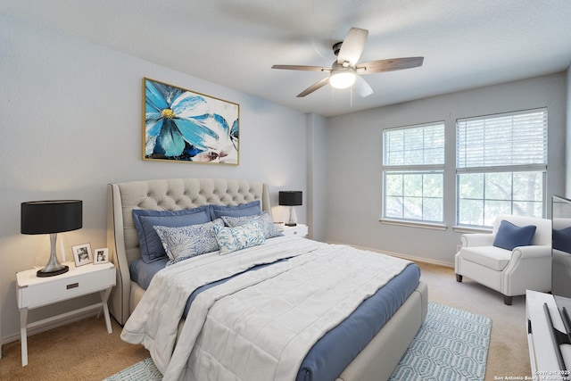 bedroom featuring light colored carpet and ceiling fan