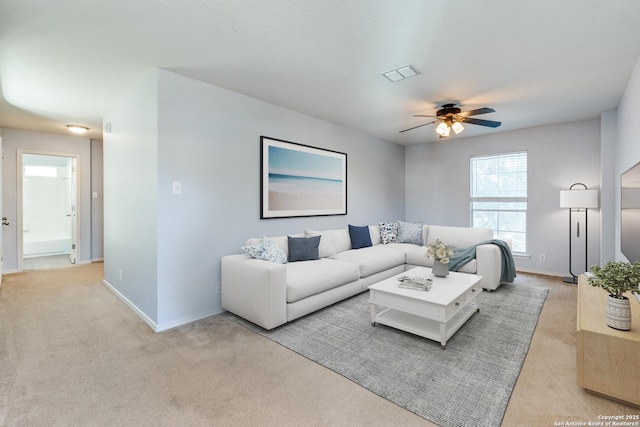 living room with light colored carpet and ceiling fan