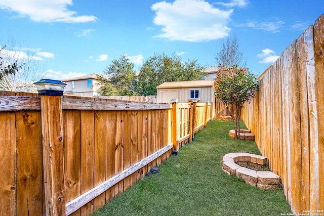 view of yard featuring a shed and a fire pit