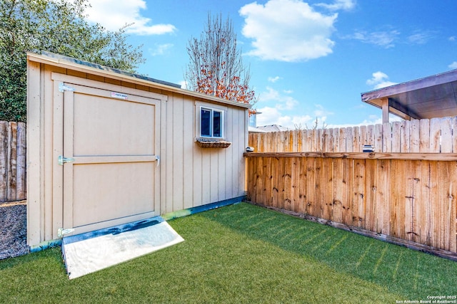 view of outbuilding featuring a lawn