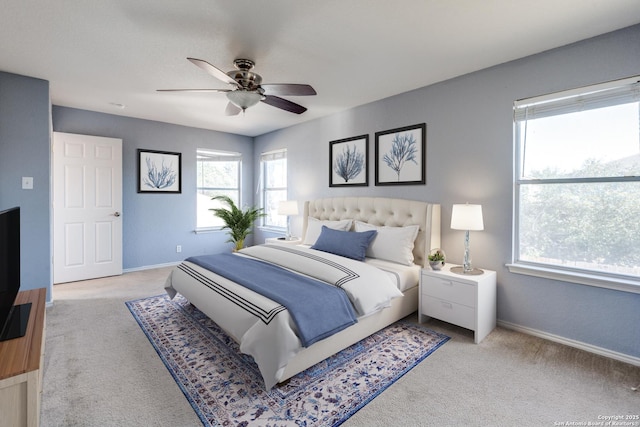 bedroom featuring light carpet and ceiling fan