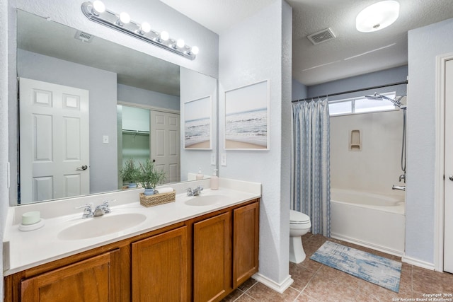 full bathroom with toilet, a textured ceiling, vanity, shower / bath combo with shower curtain, and tile patterned flooring