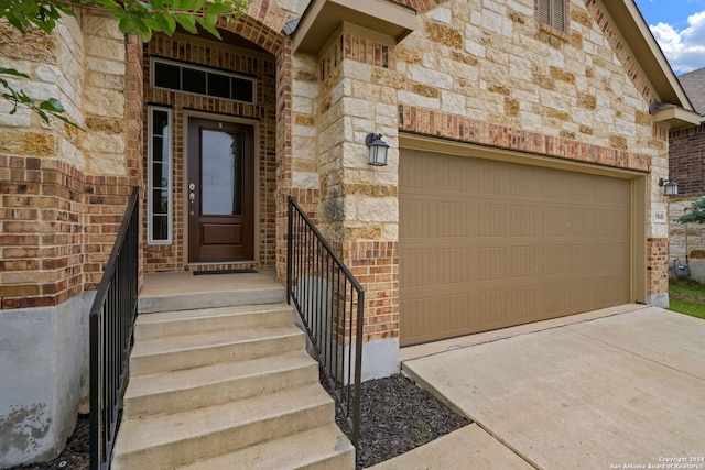 doorway to property featuring a garage