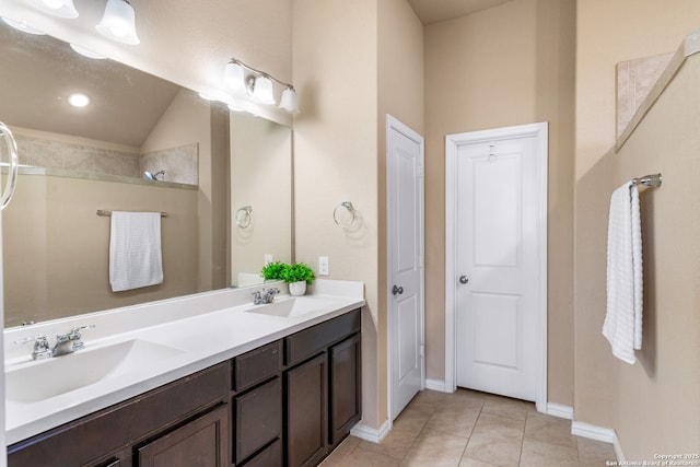 bathroom featuring tile patterned flooring, vanity, and a shower