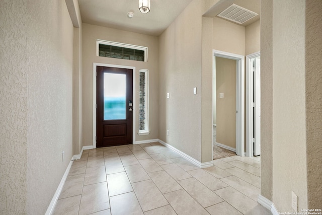 foyer entrance featuring light tile patterned flooring