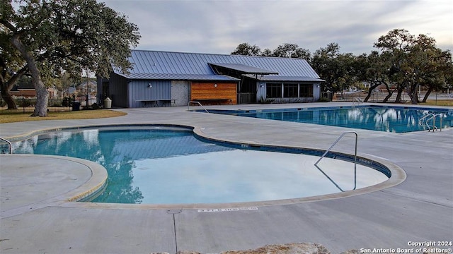 view of swimming pool with a patio area