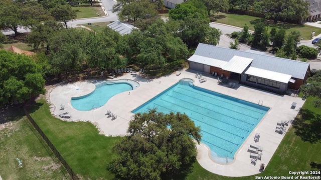 view of swimming pool featuring a lawn and a patio area