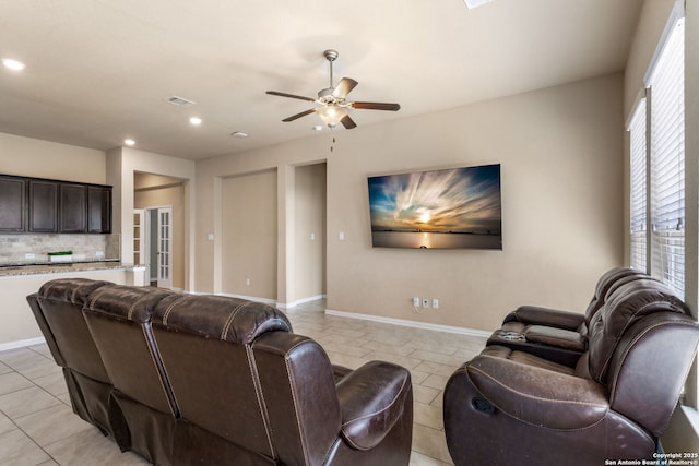 tiled living room featuring ceiling fan