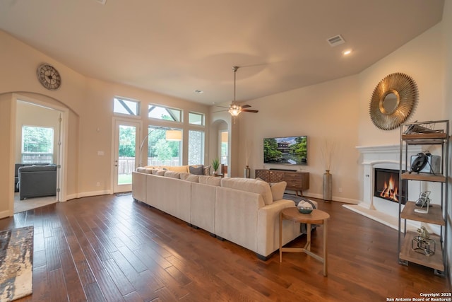 living room with dark hardwood / wood-style floors and ceiling fan