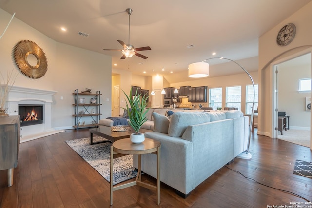 living room featuring ceiling fan and dark hardwood / wood-style flooring