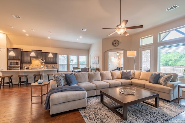 living room with dark hardwood / wood-style flooring and ceiling fan