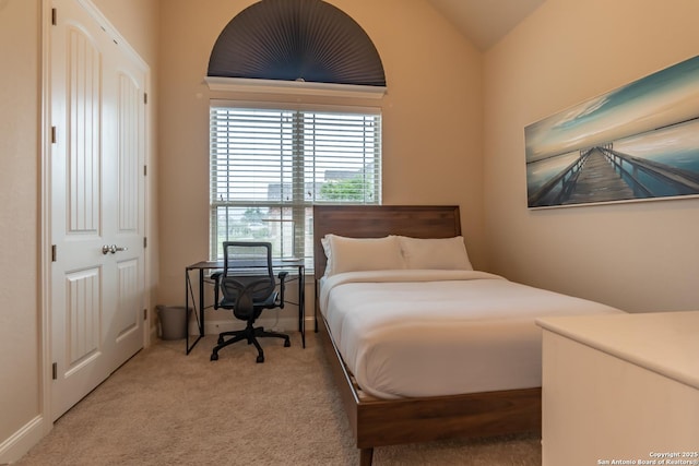 bedroom with carpet and lofted ceiling