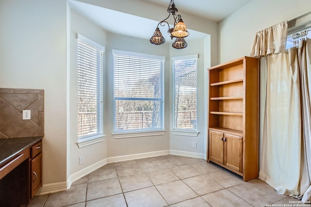 unfurnished dining area featuring light tile patterned floors and a healthy amount of sunlight