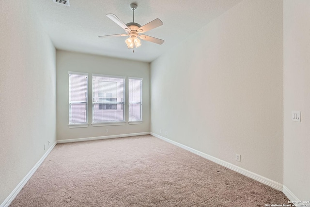 spare room with light colored carpet and ceiling fan