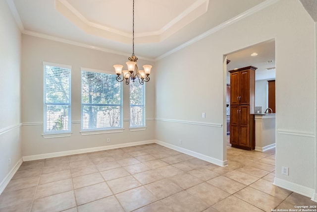 tiled empty room with crown molding, a notable chandelier, and a tray ceiling