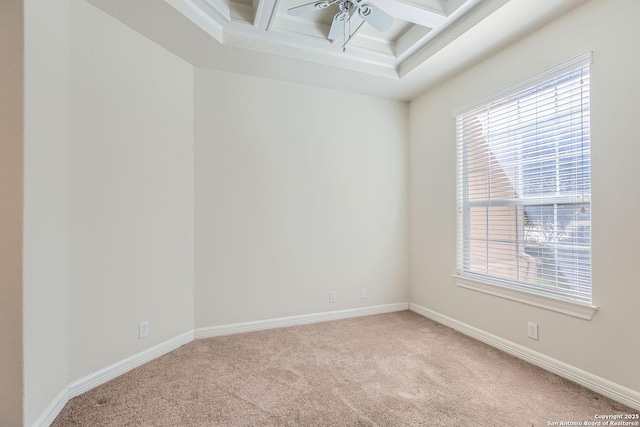 carpeted spare room featuring coffered ceiling and beam ceiling