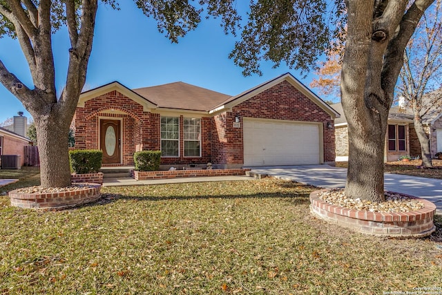 view of front of property with a garage, central AC, and a front lawn